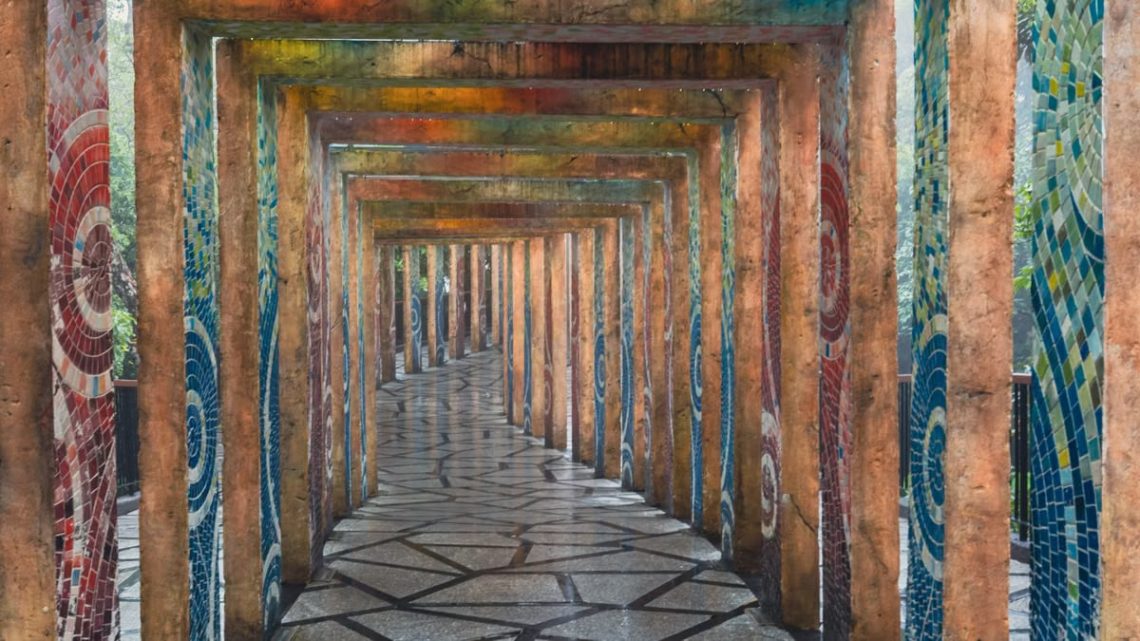 A vibrant mosaic corridor with geometric paving stones in Ba Na Hills, Vietnam.